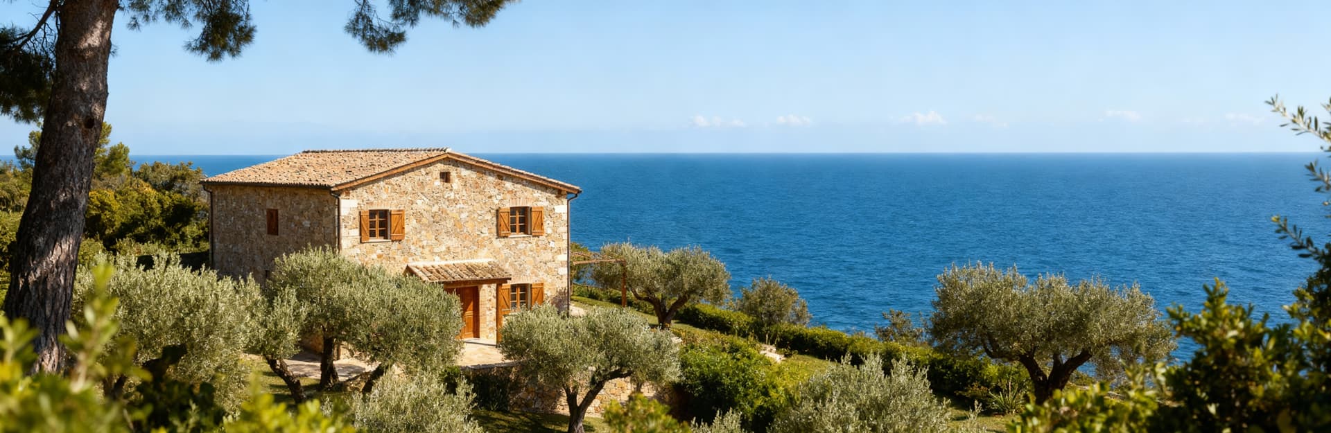 Rustico in vendita all'Argentario, architettura in pietra e legno circondato da uliveti e mare blu, panorama idilliaco.