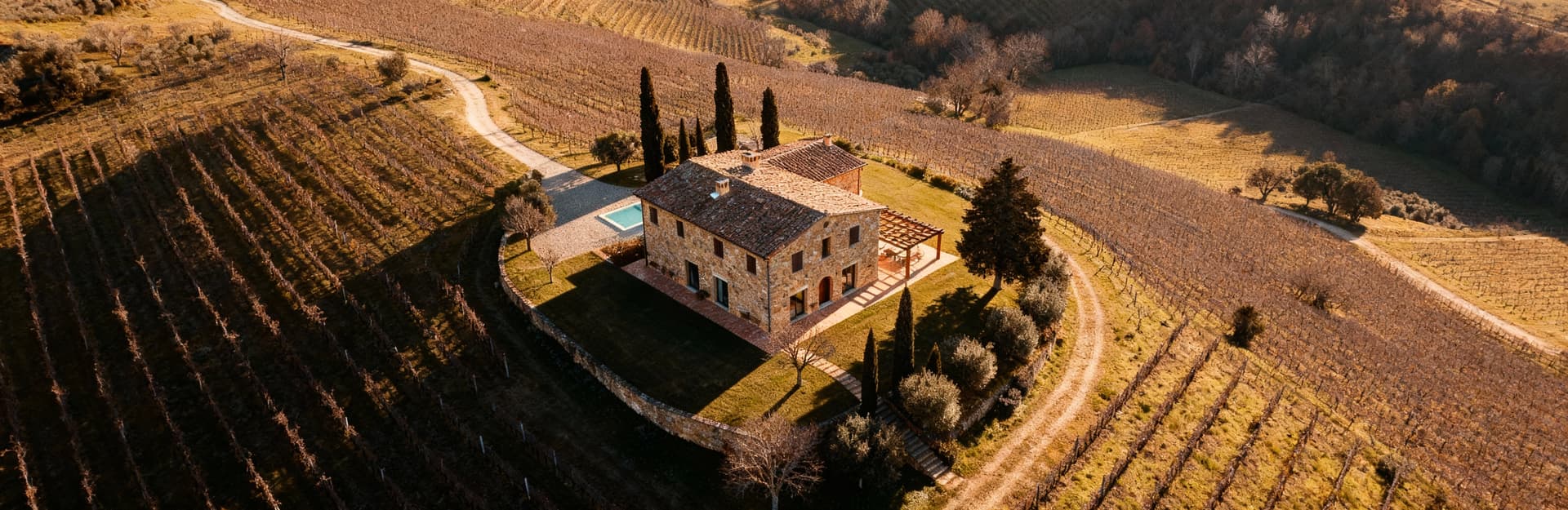 Luxury villas for sale in Chianti, surrounded by rolling hills and vineyards, featuring stunning sunsets and Chianti DOCG wine.