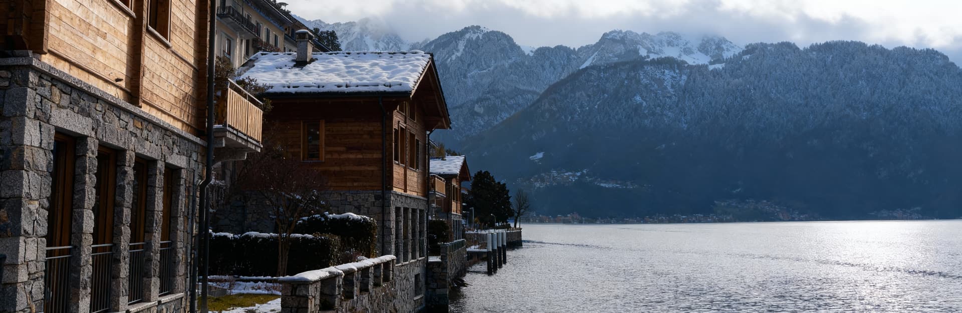 Luxury properties for sale by Lake Lugano, showcasing the stunning natural beauty of the Swiss landscape and mountains.