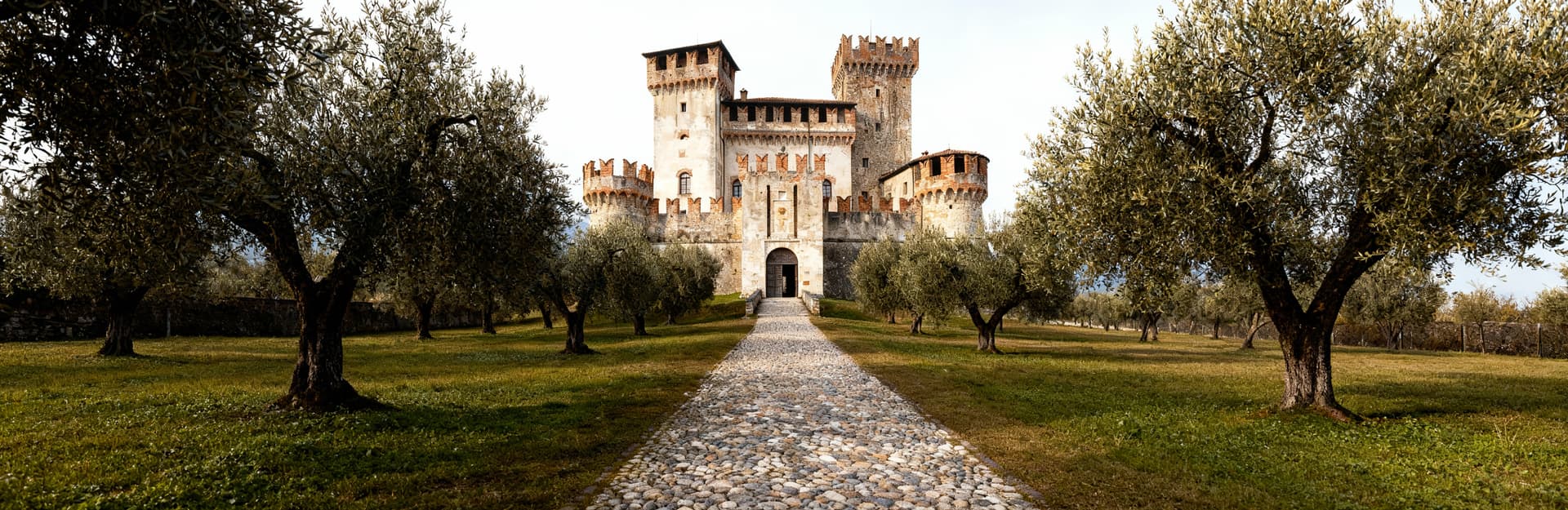 Castles for sale in Lombardy's Città, surrounded by lush hills and historic towns, offering unique architectural beauty.