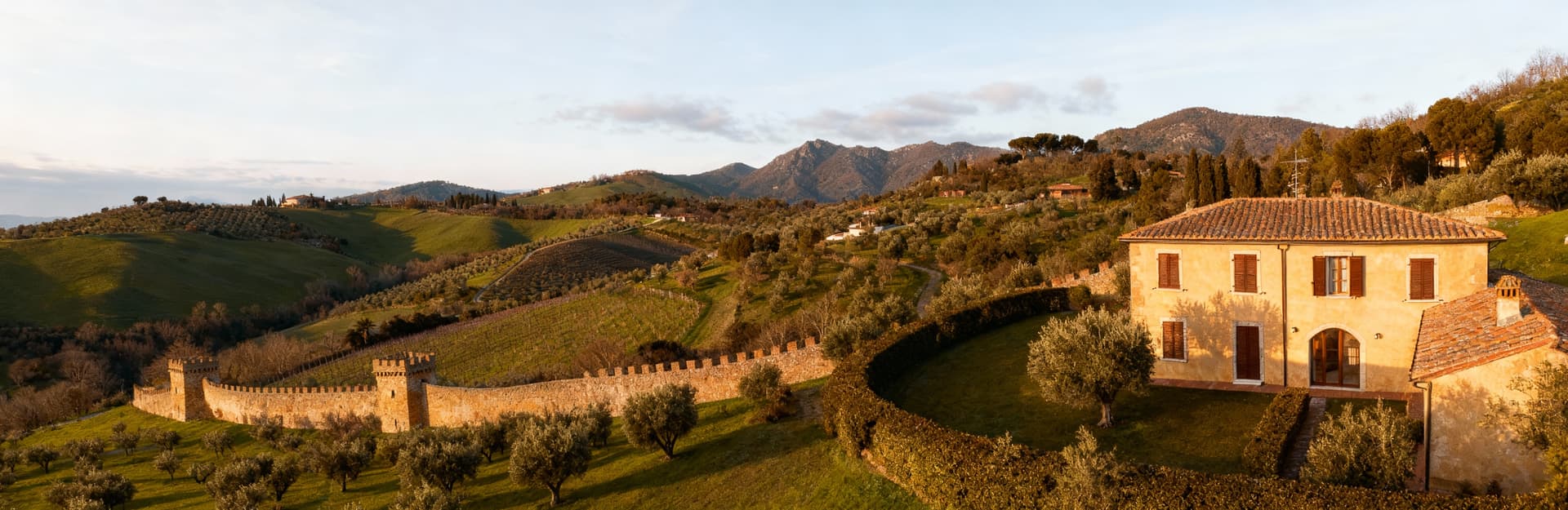 Luxury apartments for sale in Grosseto, Tuscany, showcasing stunning views of green hills and the crystal-clear Tyrrhenian Sea.