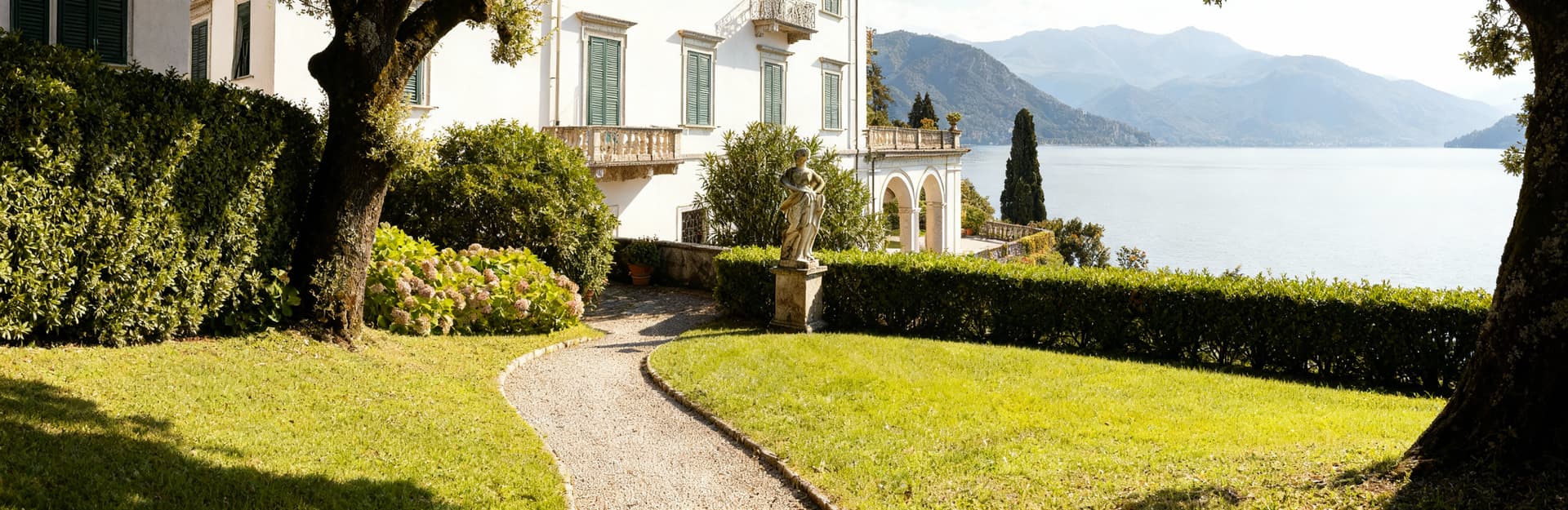 Luxury villas for sale in Como, surrounded by stunning lakeside views and historic architecture in a picturesque setting.