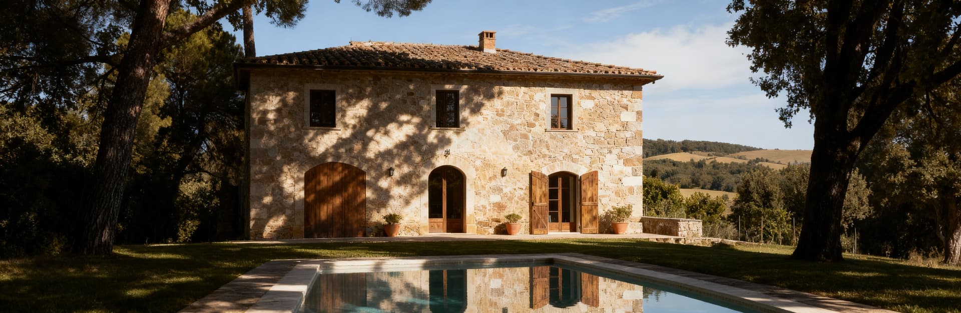 Rustic homes for sale in Versilia, Tuscany, showcasing stunning seaside views and historic architecture amidst olive groves.