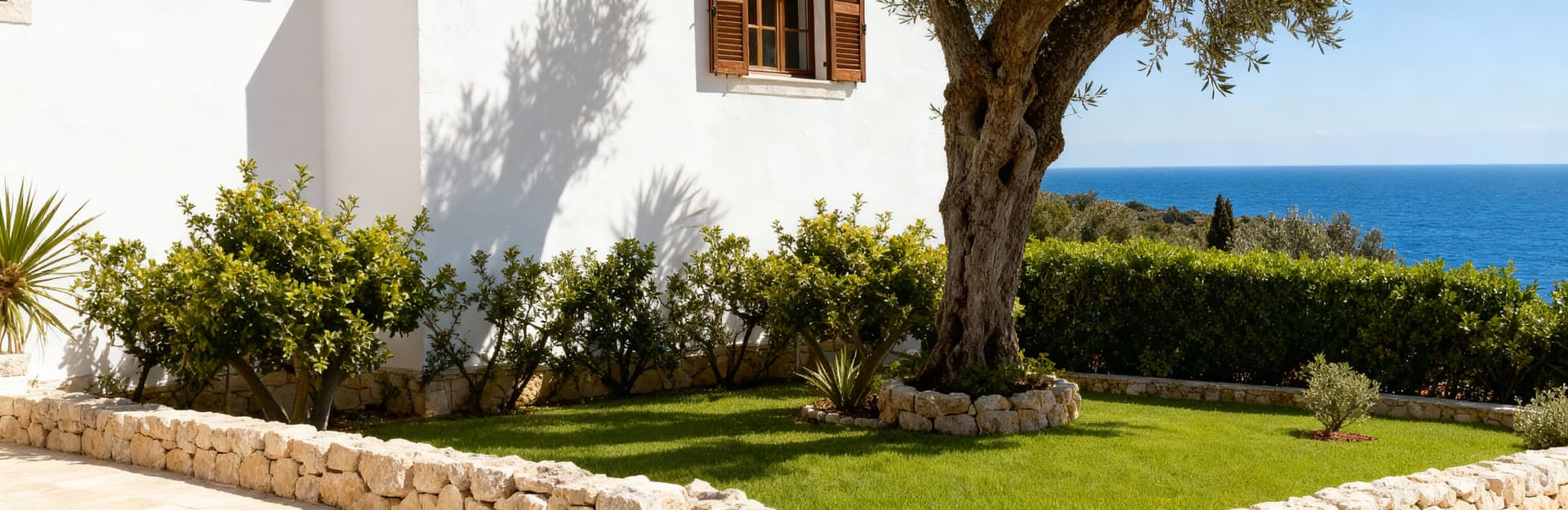 Immobili di lusso in vendita: storica masseria in pietra bianca immersa nel verde, con vista sul mare delle Isole Baleari.