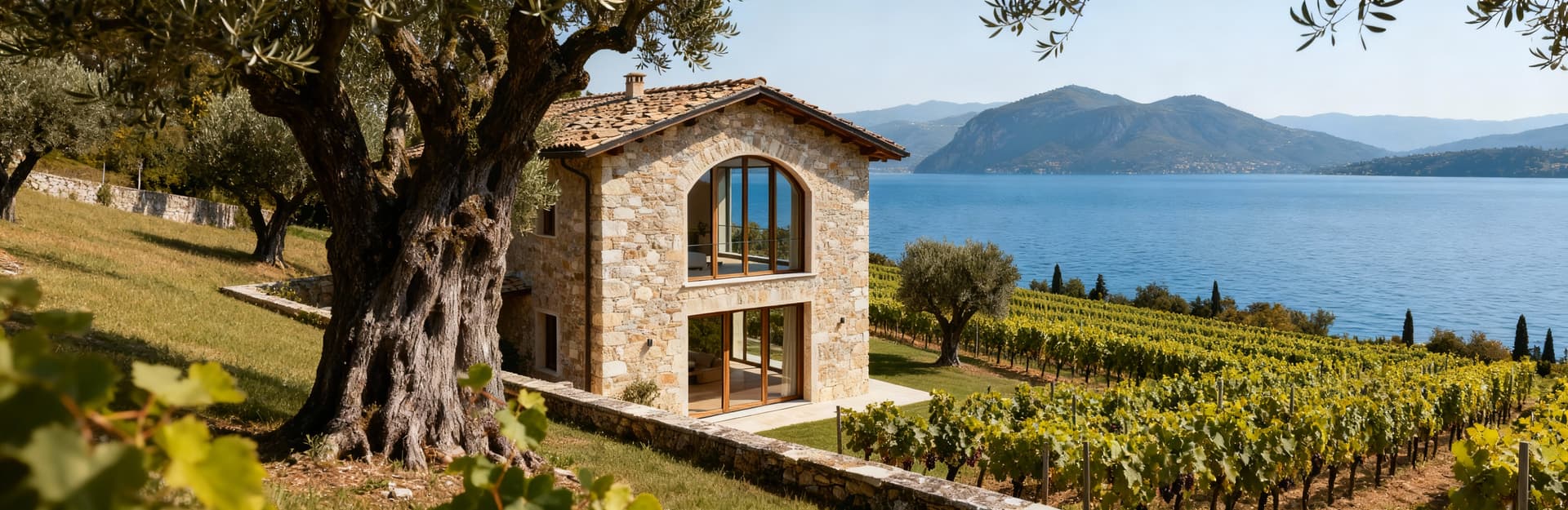 Rustic homes for sale at Lake Garda, surrounded by olive groves and vineyards, blending historic charm with modern living.