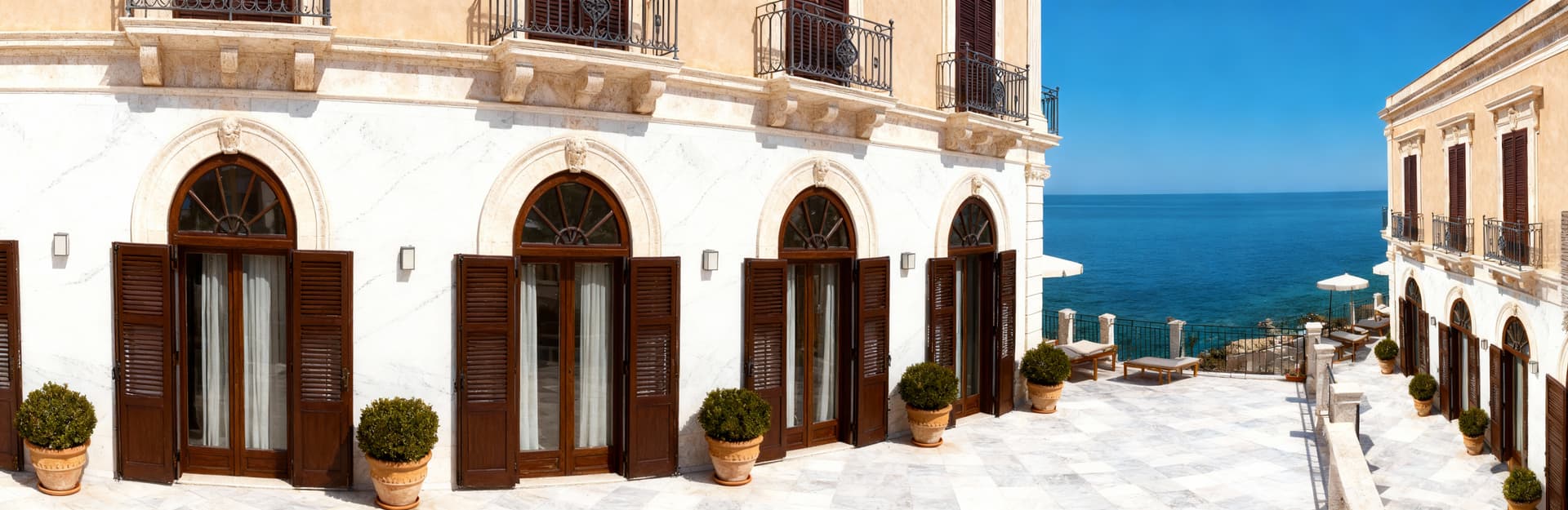 Luxury hotels for sale in Palermo, located by the sea, featuring spacious hospitality areas and premium services.