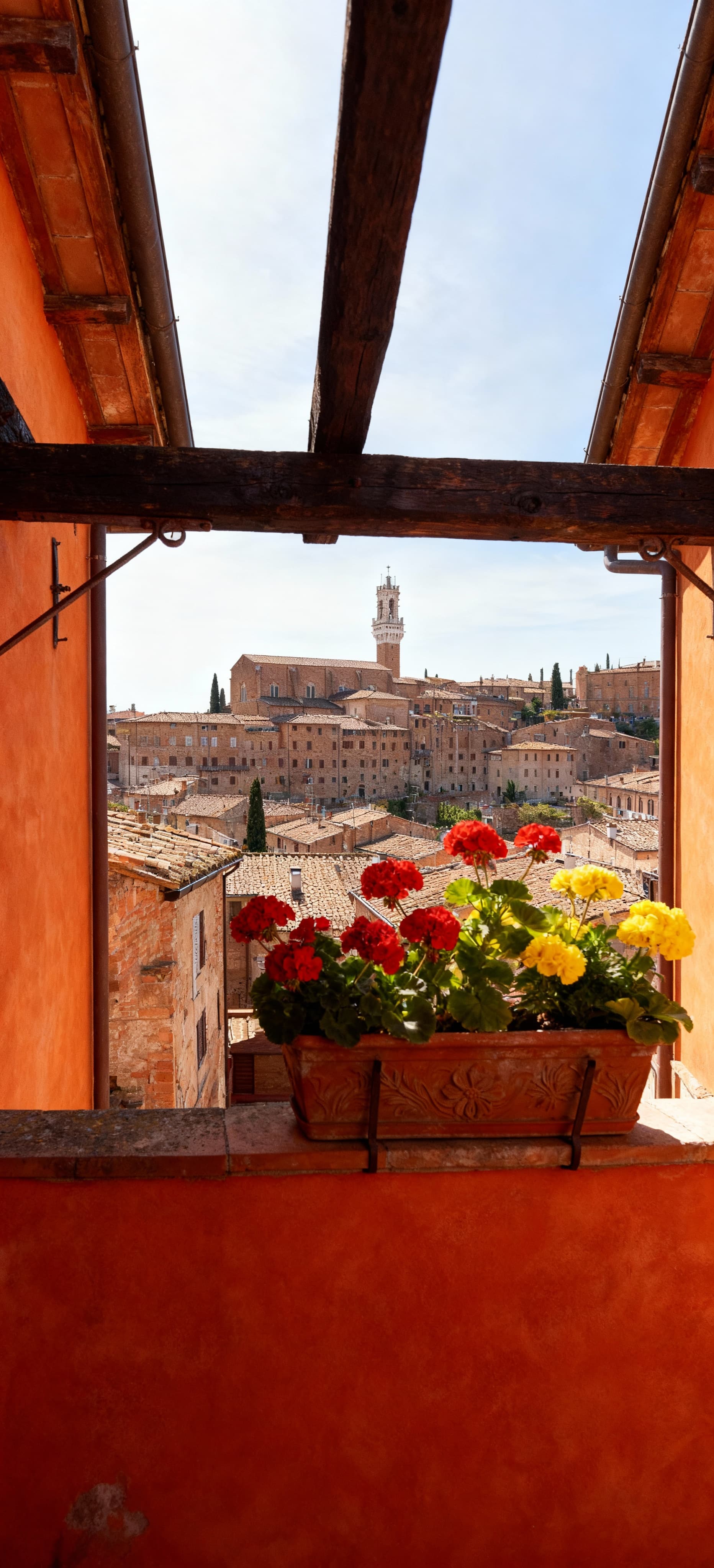 Charming townhouses for sale in Siena, Tuscany, surrounded by lush hills, vineyards, and historic architecture.