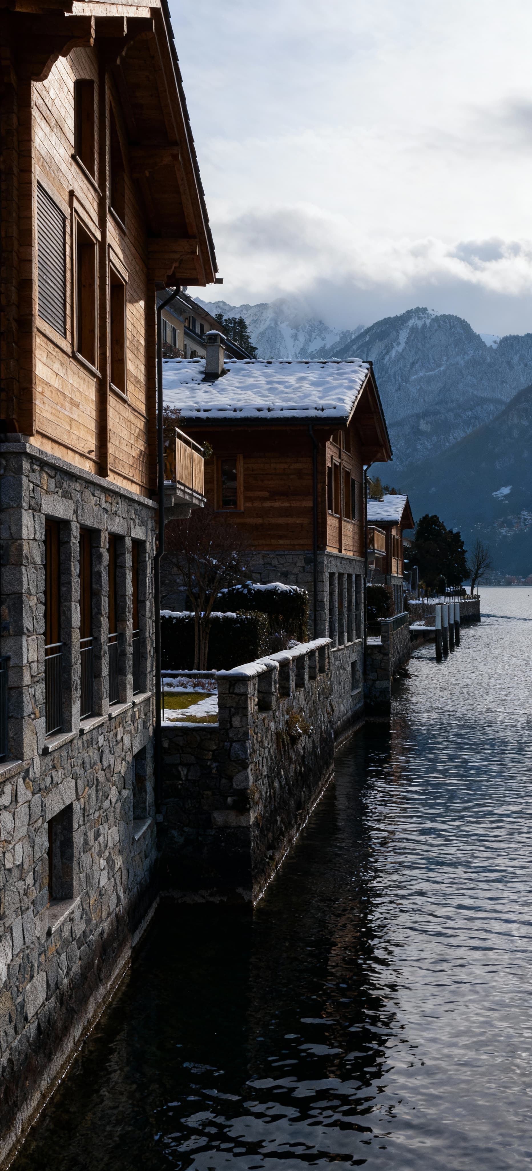 Luxury properties for sale by Lake Lugano, showcasing the stunning natural beauty of the Swiss landscape and mountains.