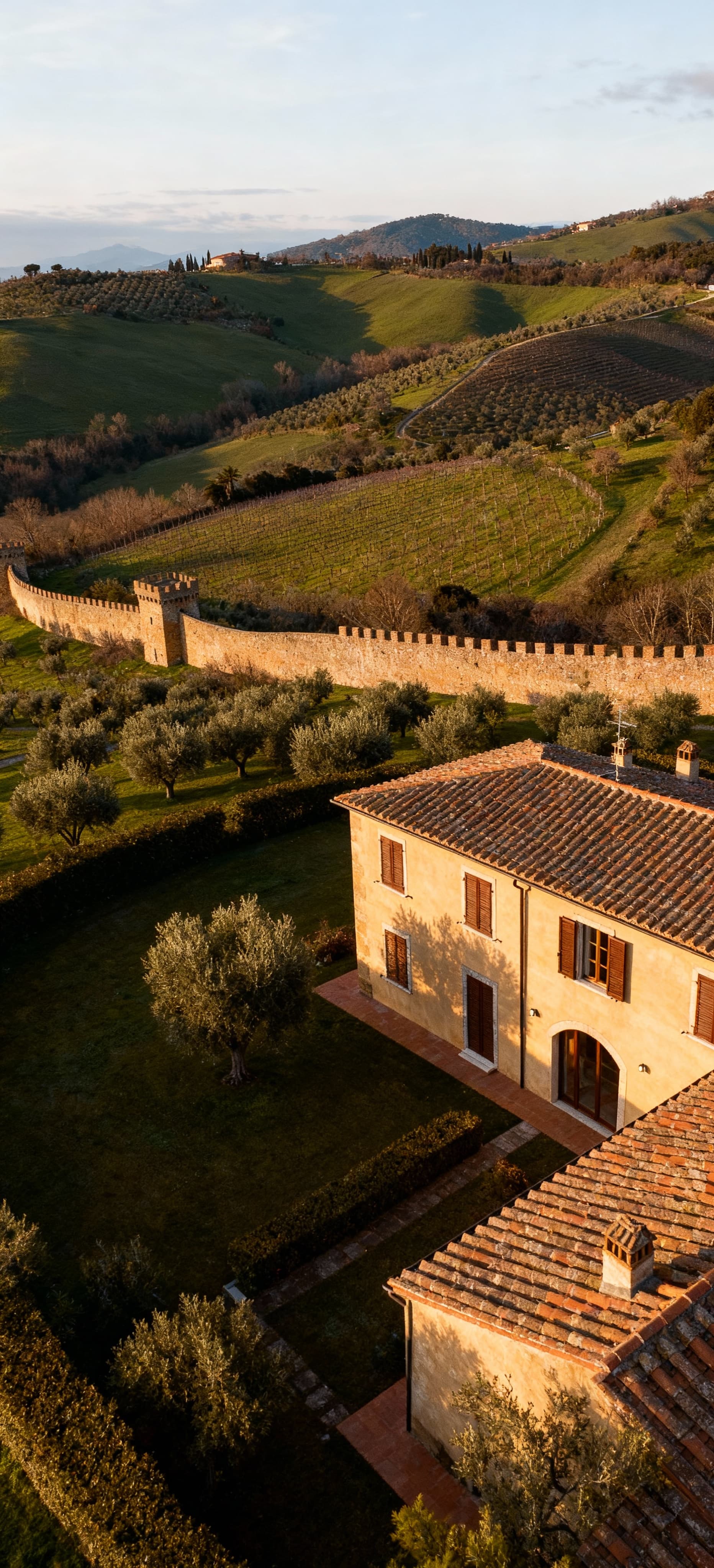 Luxury apartments for sale in Grosseto, Tuscany, showcasing stunning views of green hills and the crystal-clear Tyrrhenian Sea.