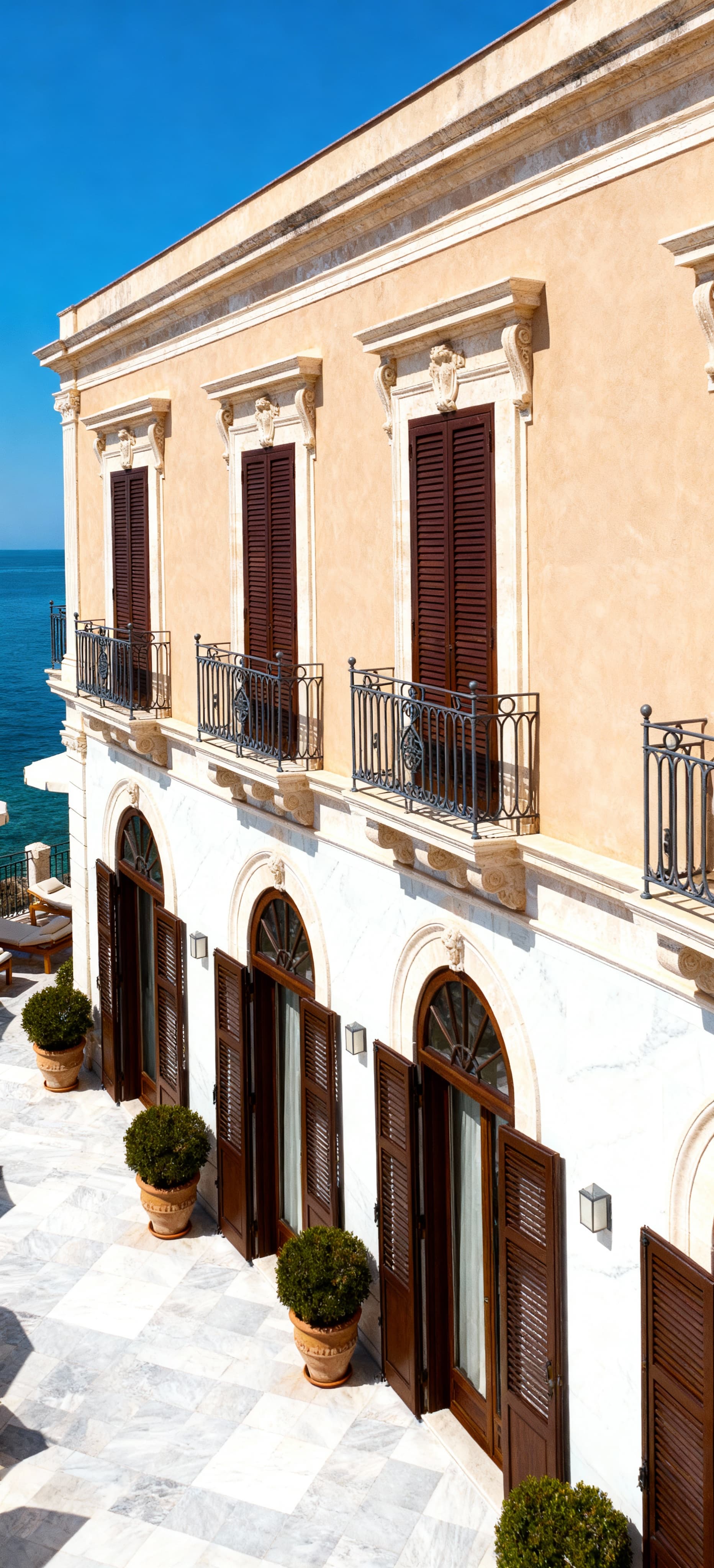 Luxury hotels for sale in Palermo, located by the sea, featuring spacious hospitality areas and premium services.