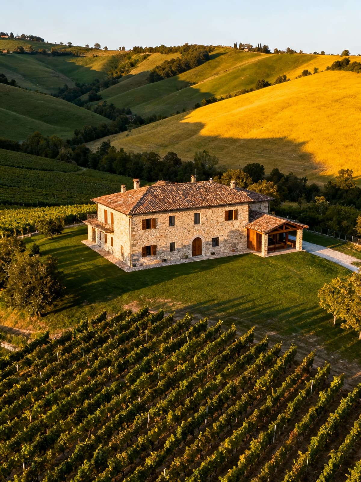 Charming rustic villa nestled among Piacenza's hills and vineyards, illuminated by soft late afternoon light.