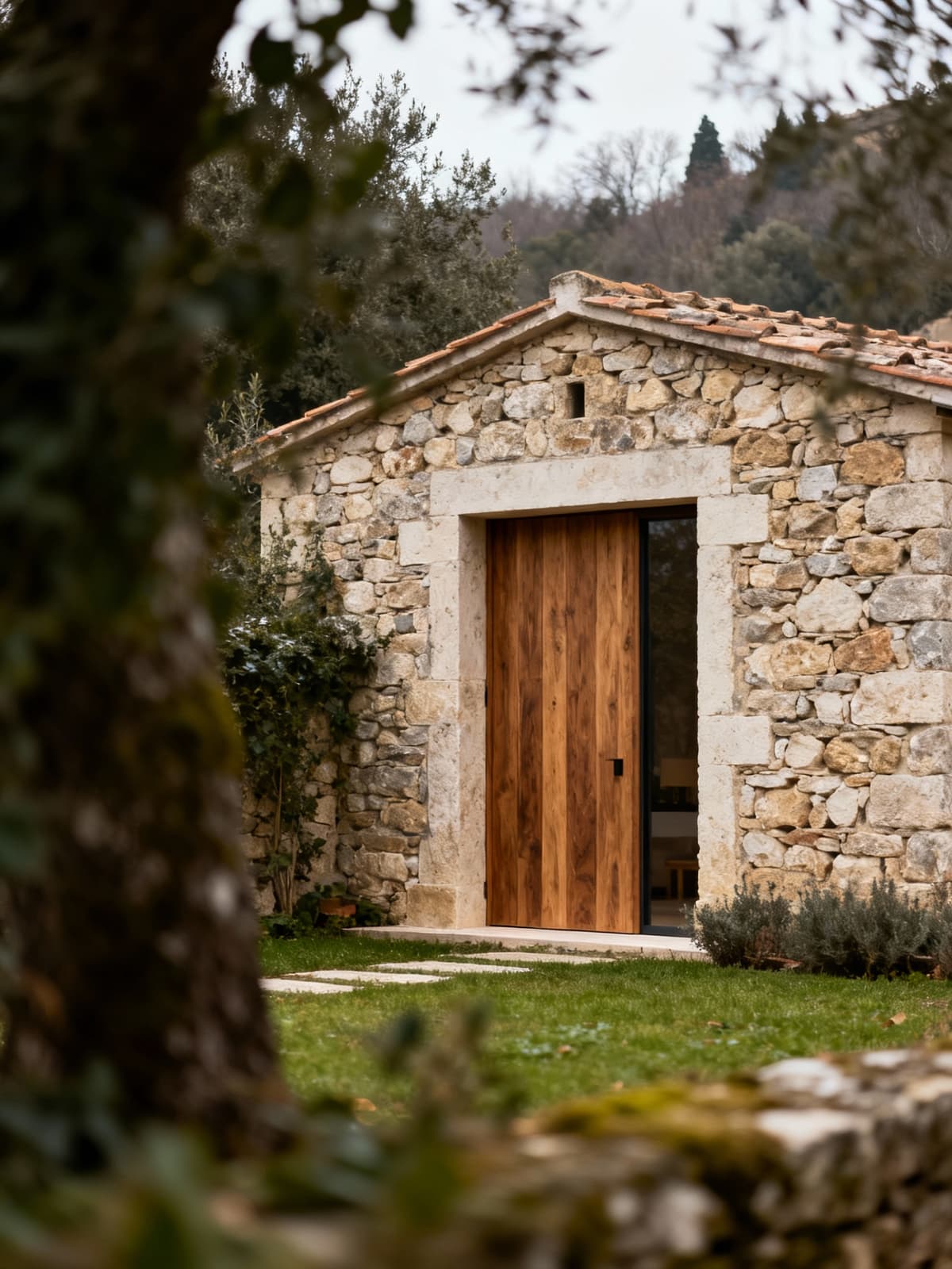 Exclusive townhouses in Lazio blend history and modernity, showcasing stone walls and wooden fixtures amidst lush greenery.